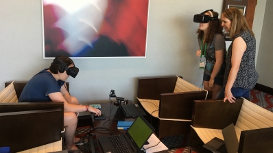 A mom watches her children participate in virtual reality research.